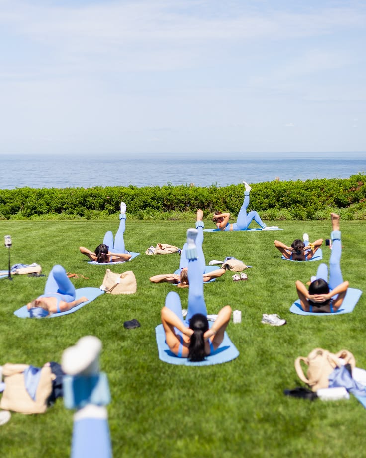 Women practicing Pilates on a lawn